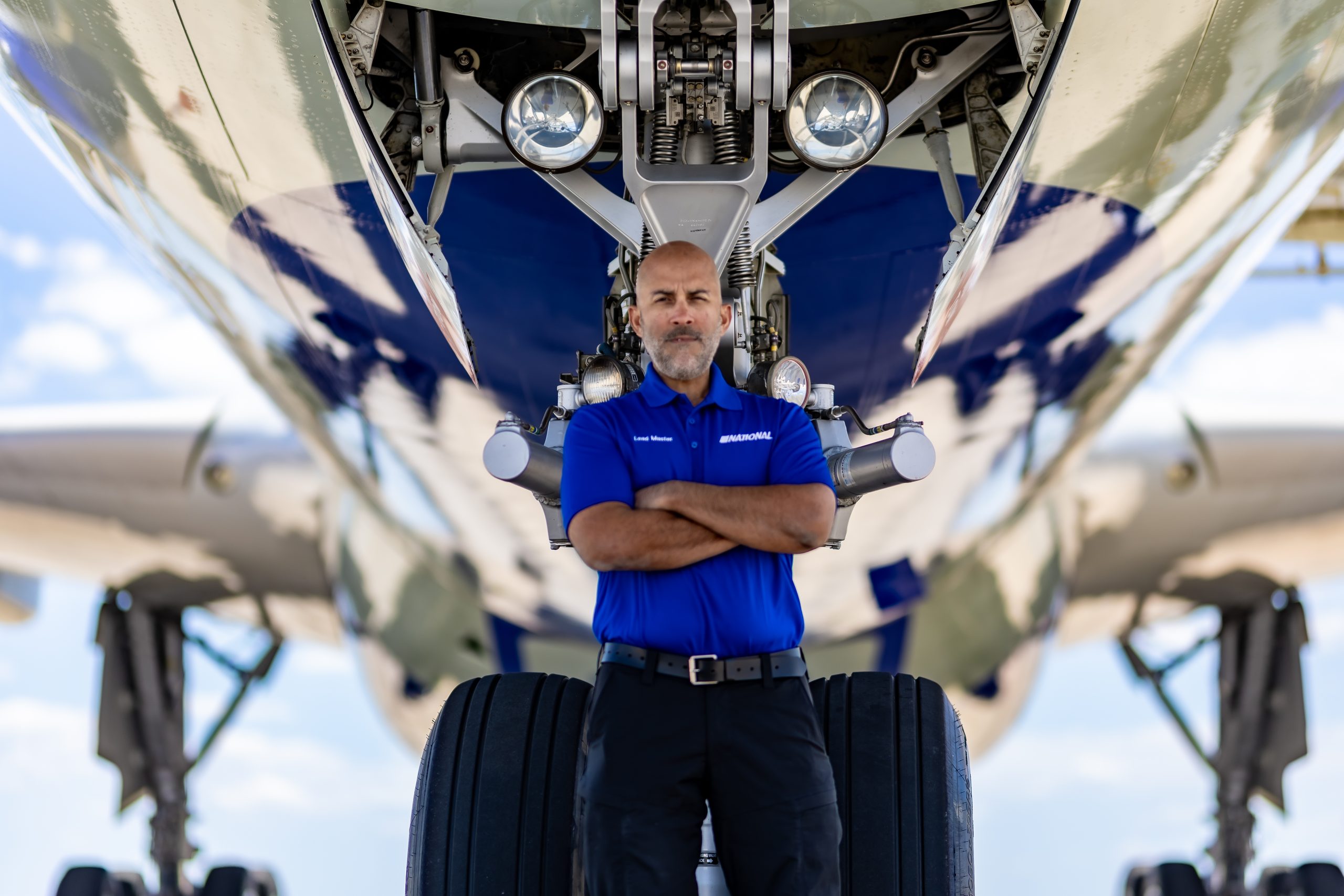 A worker standing beside an airplane