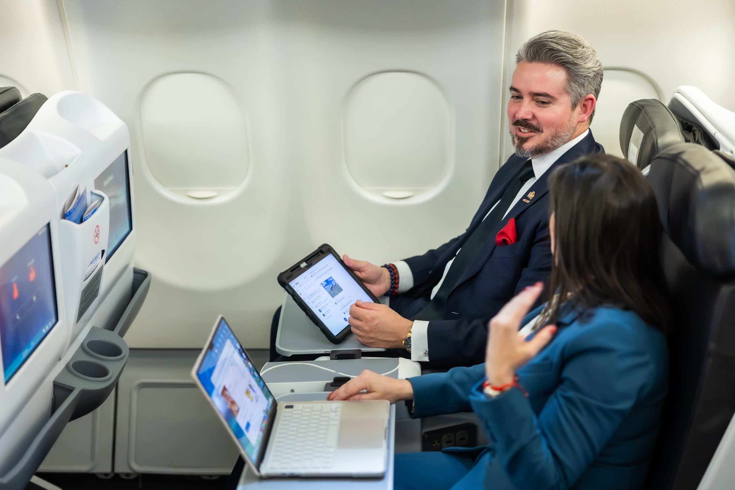 Passengers on an airplane talking to each other