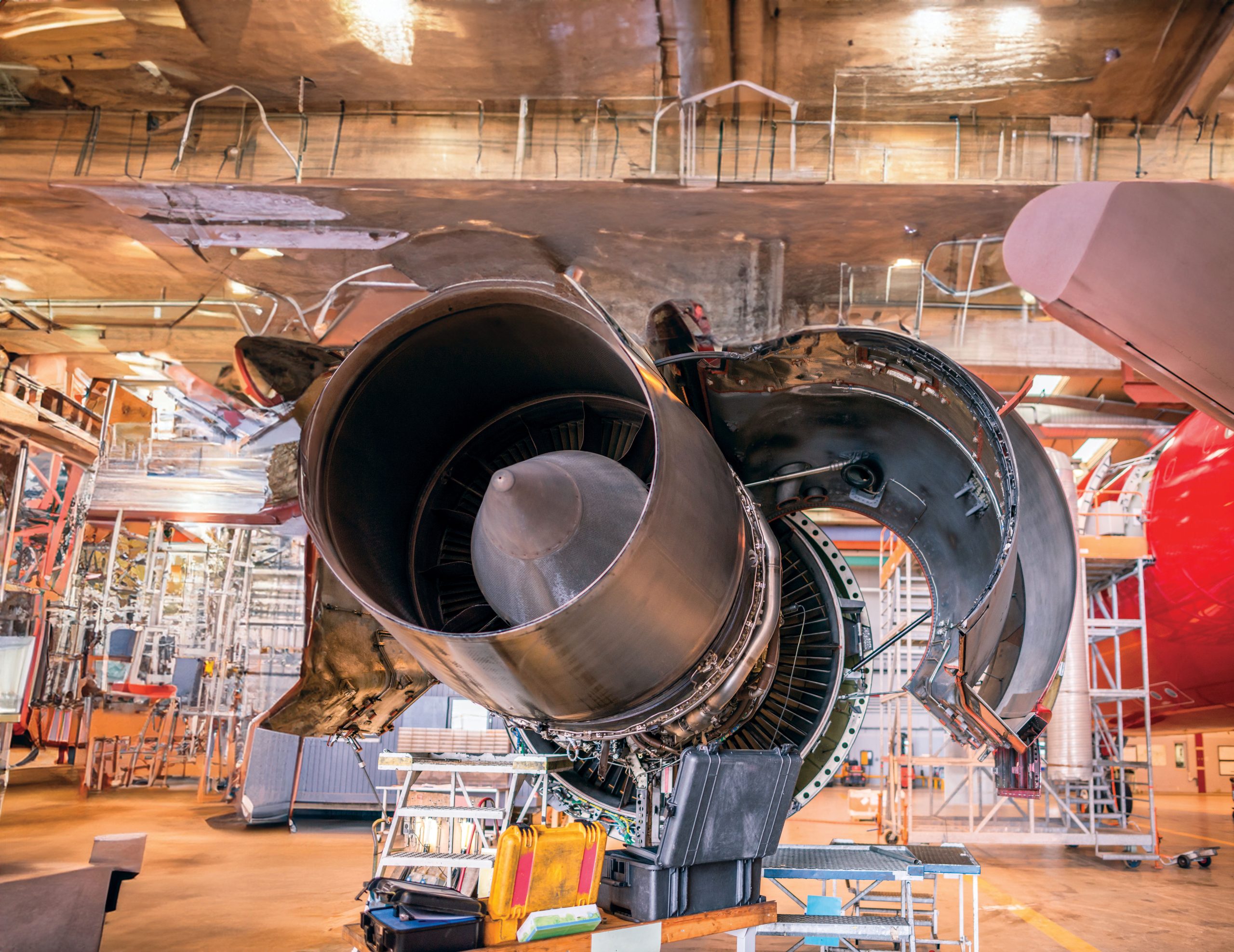 An airplane engine in a large hangar