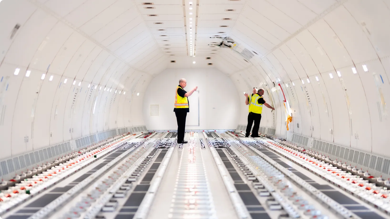 Workers in the cargo hold of an airplane