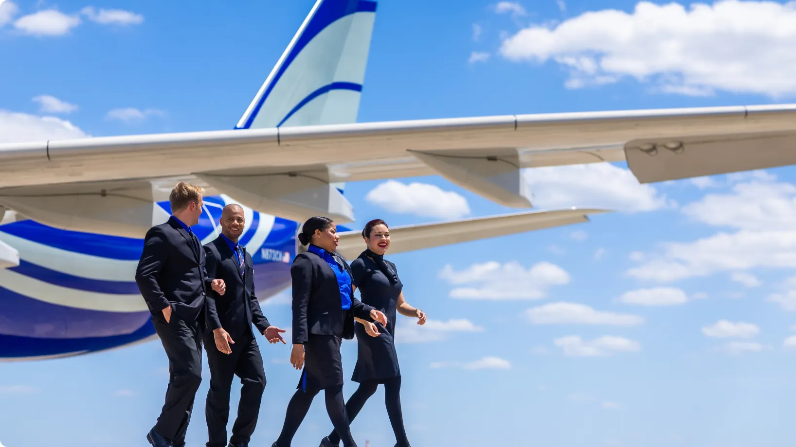 A group of workers beside an airplane