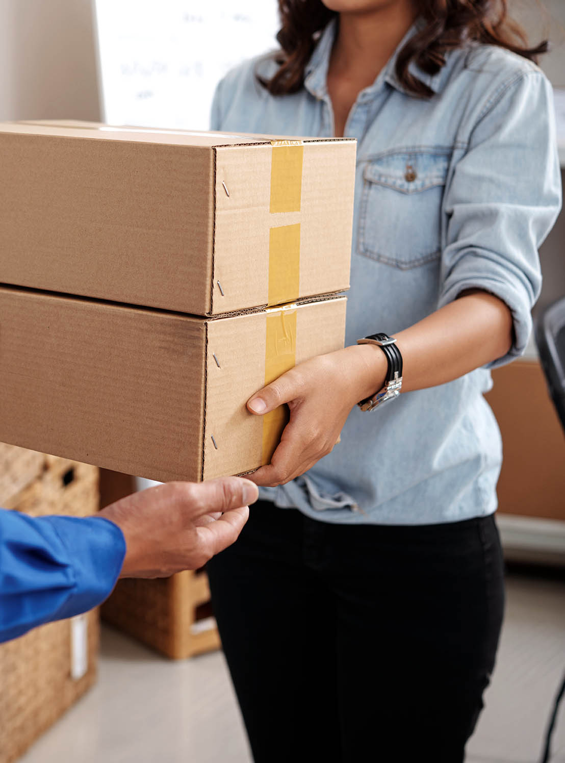 A person handing packages to another person