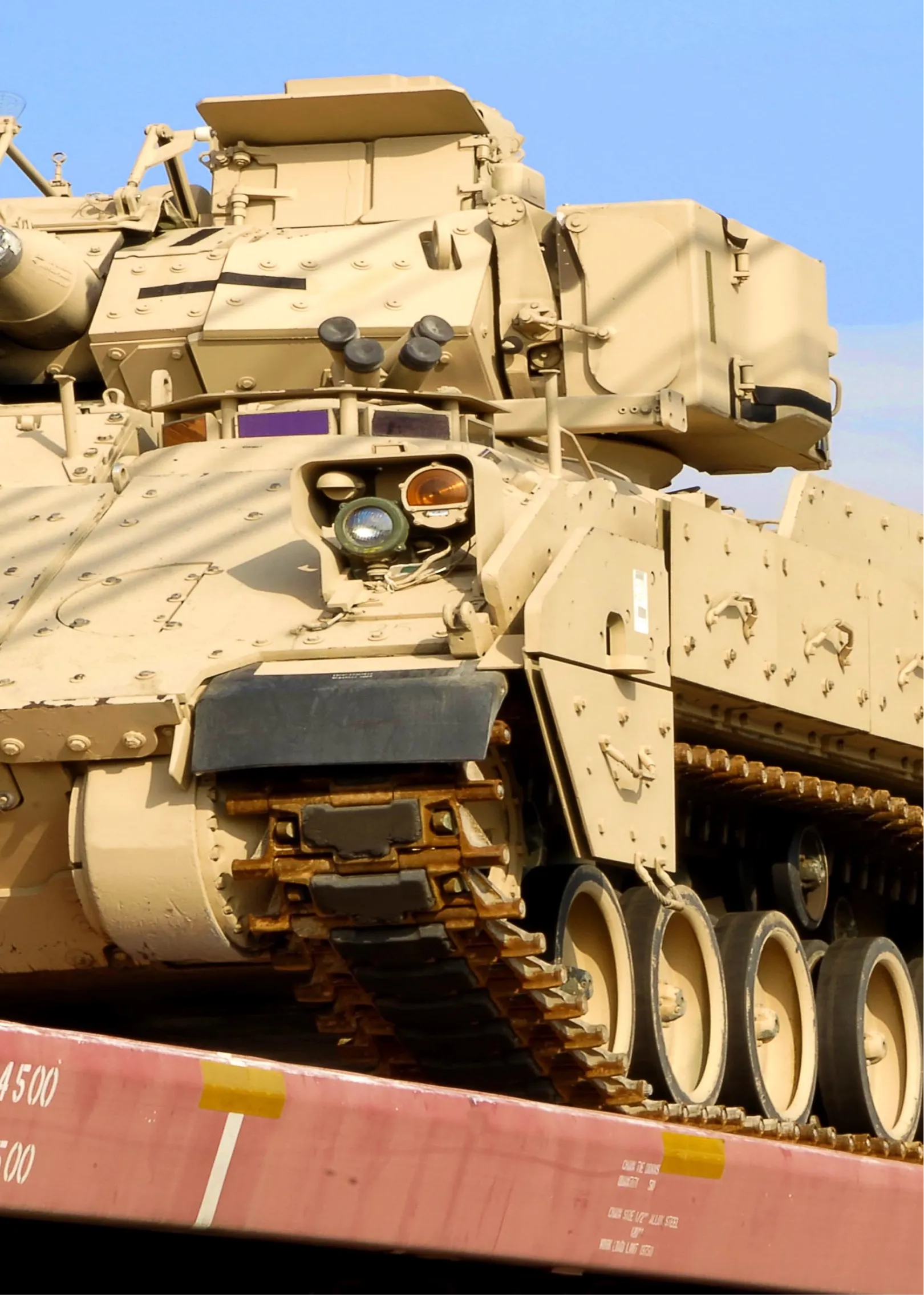 Military vehicles being loaded as cargo