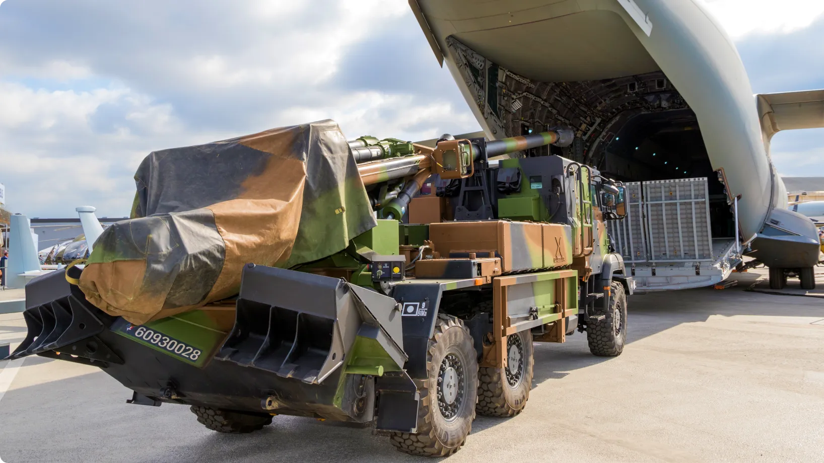 A military vehicle being loaded as cargo