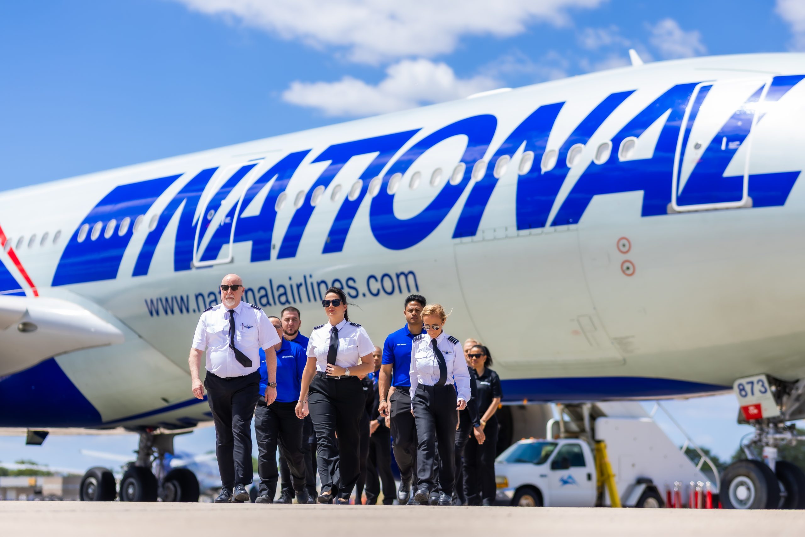 A group of workers beside an airplane