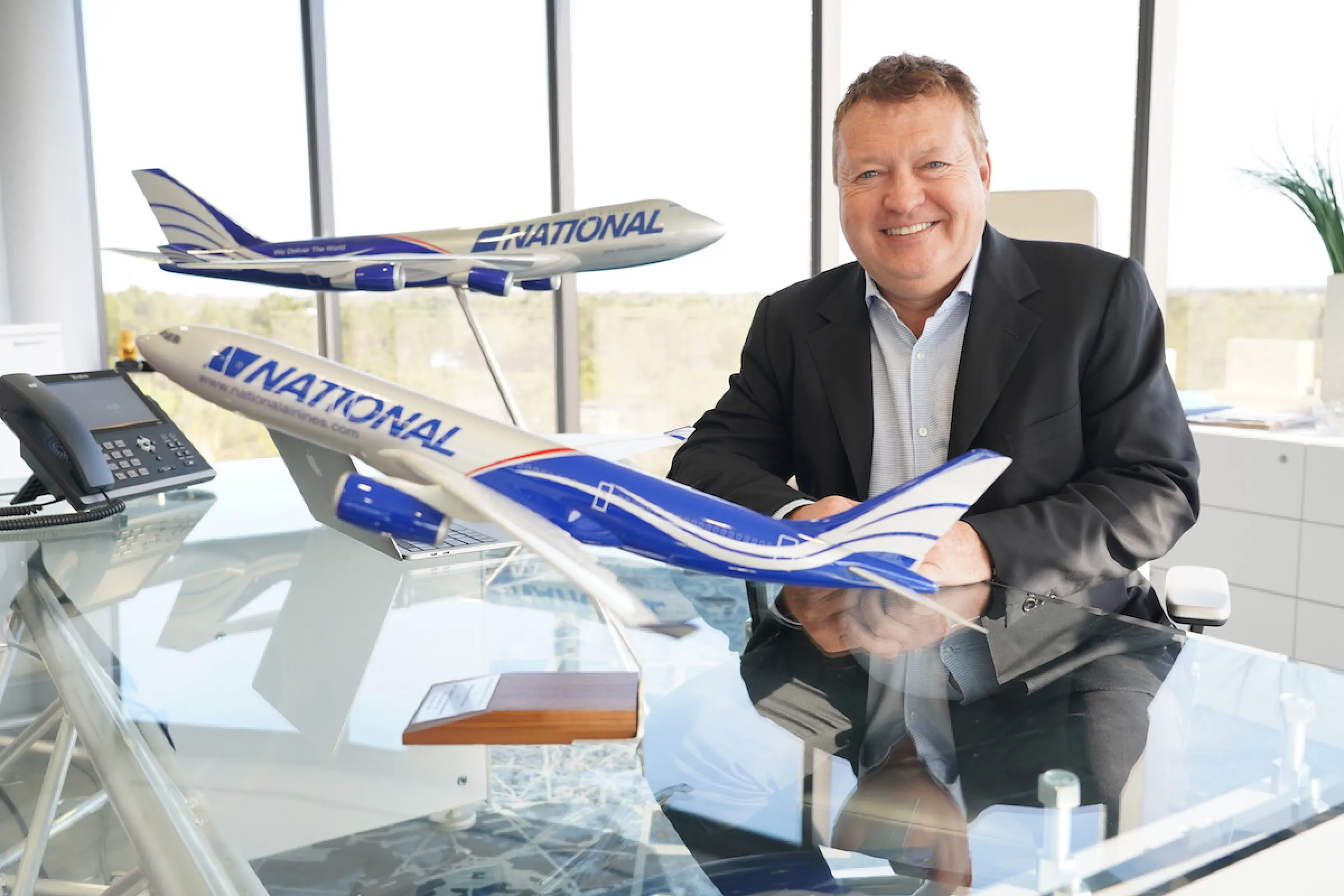 The National Air Cargo Chairman beside model airplanes