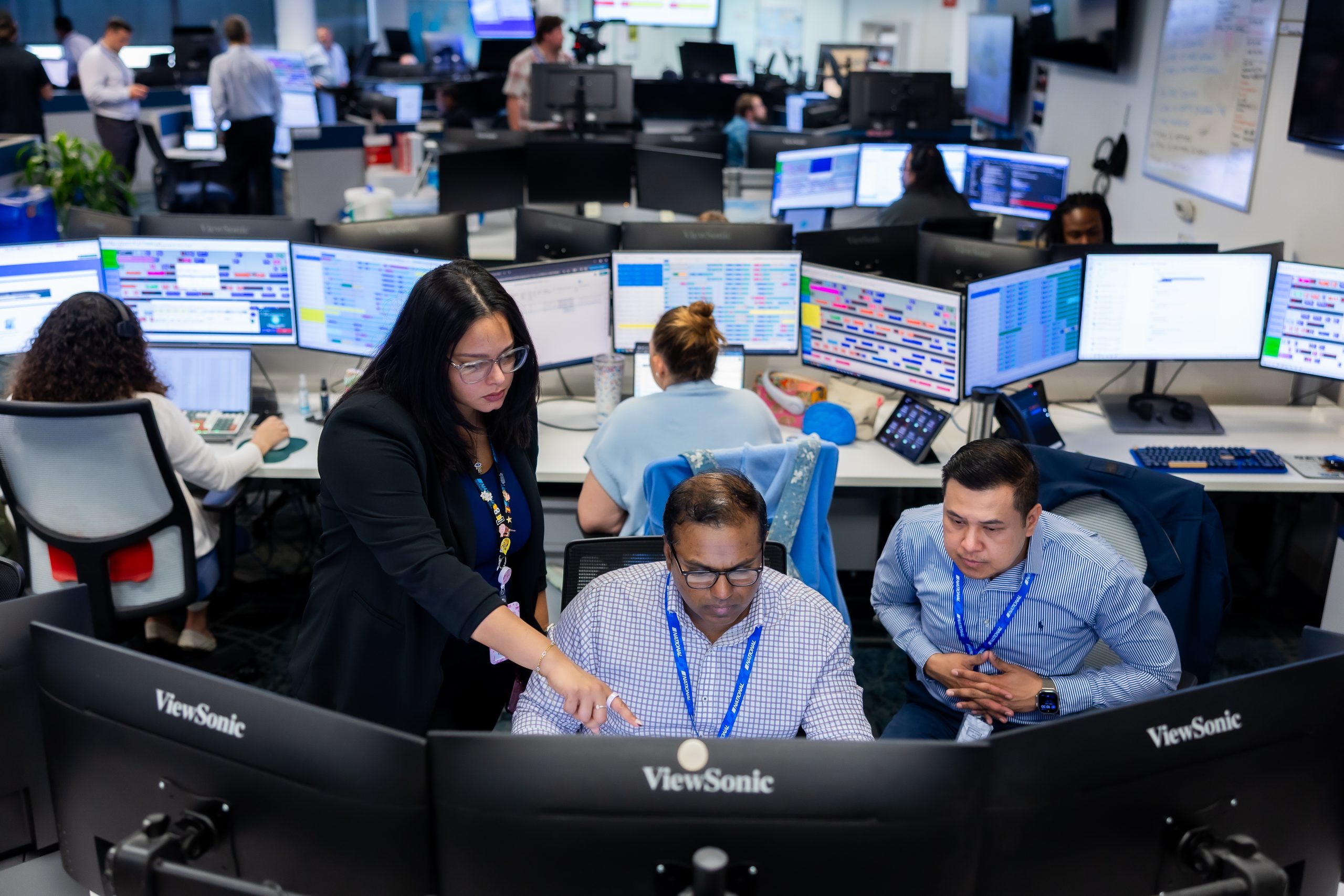 Multiple workers monitoring screens