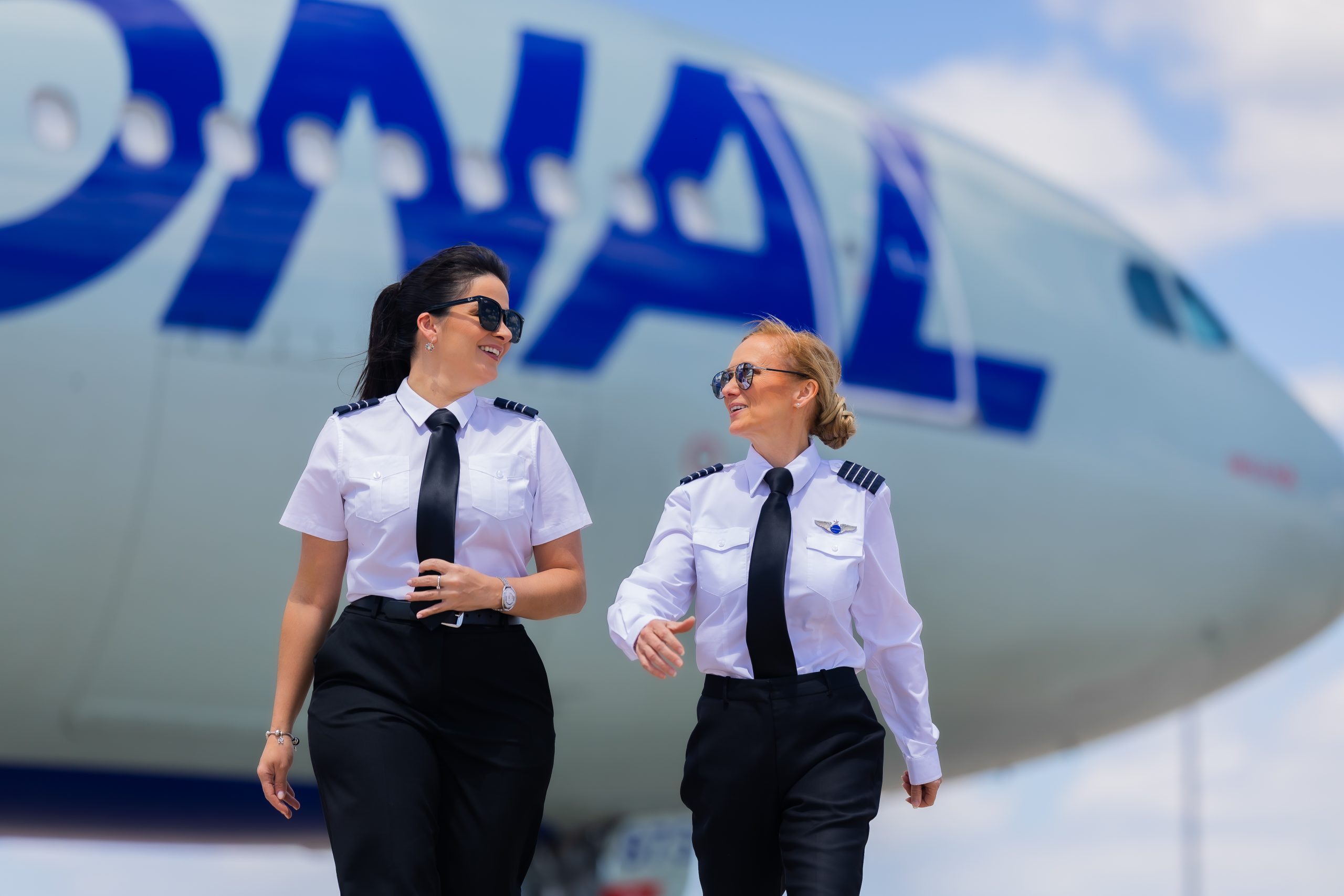 Two pilots beside an airplane